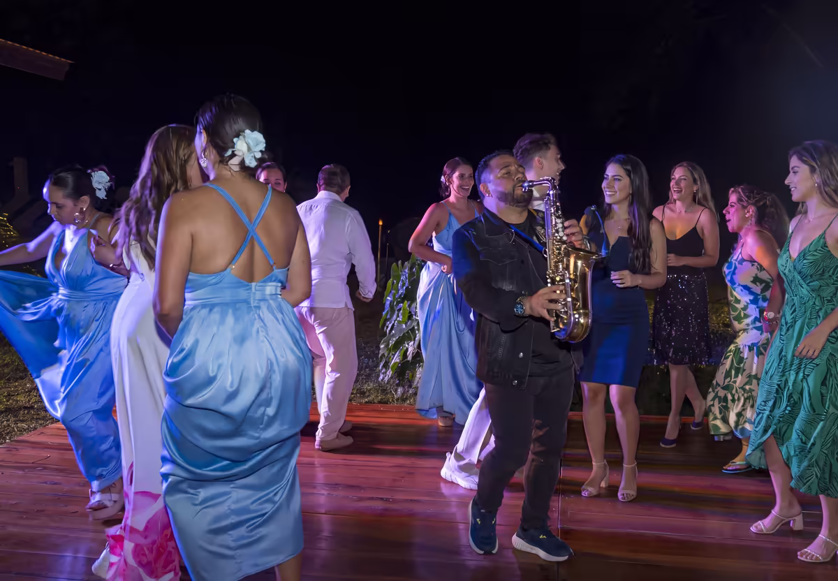 Música en vivo y baile en un evento en Villeta Invitados bailando mientras un saxofonista toca en vivo durante una fiesta en Villeta